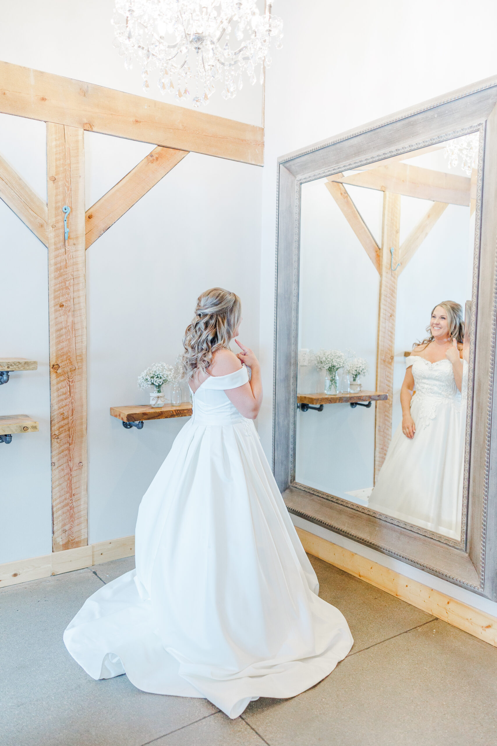 Bride taking getting ready photos inside the bridal suite at The Meadow Barn at Country Orchard Wedding