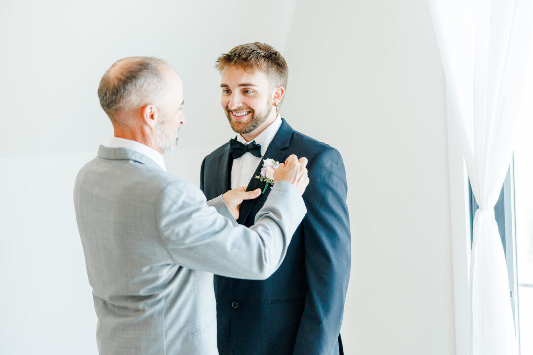groom getting ready in A-frame airbnb at barn at aspen acres wedding