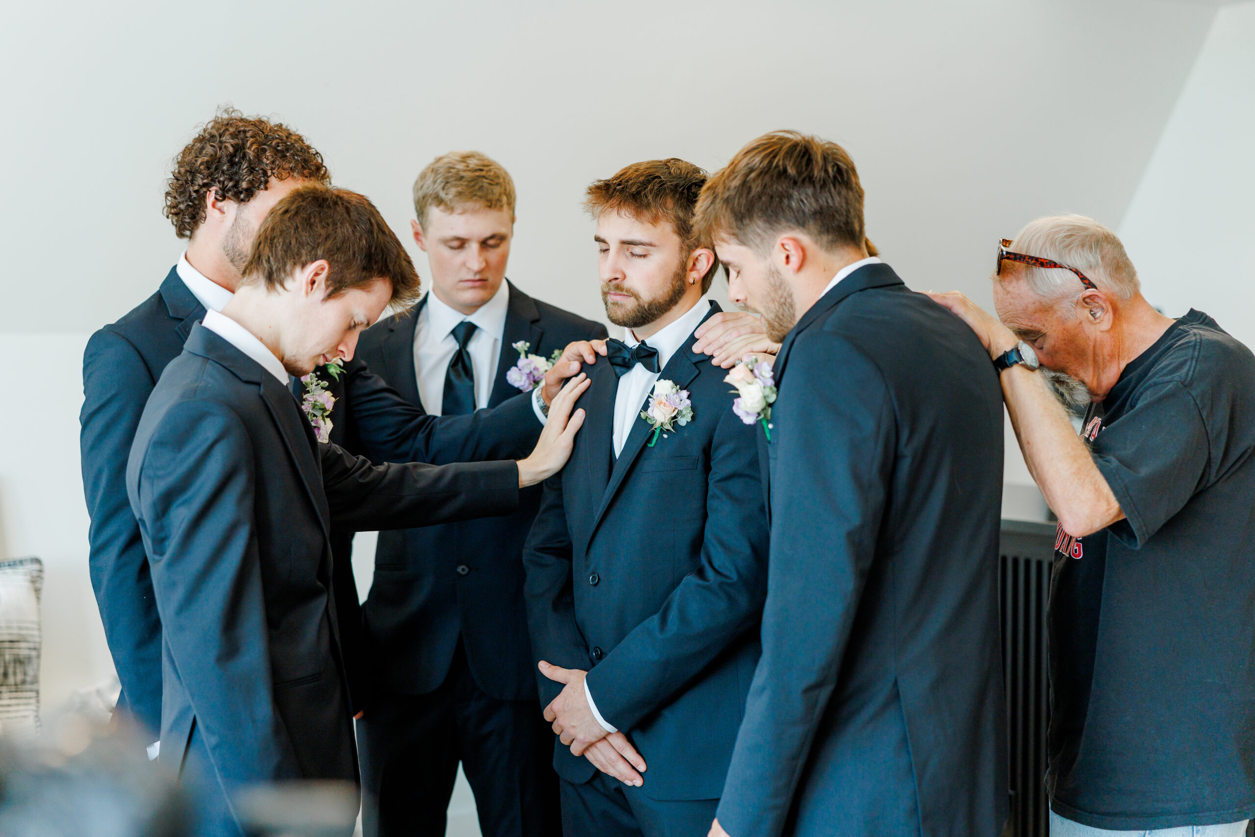 groom getting ready in A-frame airbnb at barn at aspen acres wedding